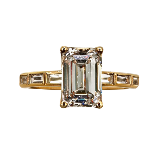 A yellow gold ring featuring a large emerald-cut clear center stone with baguette side stones, set against a plain white background.